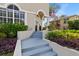 Charming front entrance with decorative wreaths, plants, and a pillar supporting an arched entryway at 230 Columbia Dr, Tampa, FL 33606