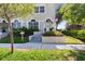 Inviting front entrance with steps leading to a charming home, enhanced by colorful landscaping at 230 Columbia Dr, Tampa, FL 33606