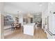 Open concept kitchen with a large island, pendant lighting, and dining area, ideal for entertaining at 230 Columbia Dr, Tampa, FL 33606