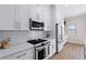 Kitchen area featuring stainless steel appliances, quartz counters, and updated cabinetry at 230 Columbia Dr, Tampa, FL 33606