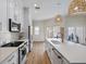 Kitchen boasts an island with seating, quartz countertops, and modern appliances at 230 Columbia Dr, Tampa, FL 33606