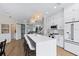Bright kitchen with white cabinets, stainless steel appliances, and a stylish island for seating at 230 Columbia Dr, Tampa, FL 33606