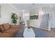 Open-concept living room with hardwood floors and a staircase leading to the upper level at 230 Columbia Dr, Tampa, FL 33606