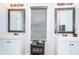Dual vanity bathroom with decorative mirrors, cabinet, and sink with modern fixtures at 2320 E 12Th Ave, Tampa, FL 33605