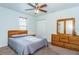 Welcoming bedroom with a ceiling fan, closet, and dresser for ample storage at 2320 E 12Th Ave, Tampa, FL 33605