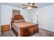 Cozy bedroom with a ceiling fan, carpet flooring, and a wooden bed frame at 2320 E 12Th Ave, Tampa, FL 33605