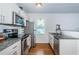 Modern kitchen with stainless steel appliances, granite countertops, and ample natural light at 2320 E 12Th Ave, Tampa, FL 33605