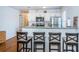 Open-concept kitchen with breakfast bar, white cabinetry, and granite countertops, perfect for entertaining at 2320 E 12Th Ave, Tampa, FL 33605