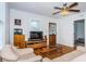 Cozy living room featuring hardwood floors, a ceiling fan, and comfortable seating at 2320 E 12Th Ave, Tampa, FL 33605