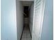 Hallway with door open to attic access with ladder ready to be renovated at 2402 E 148Th Ave, Lutz, FL 33549