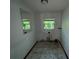 Bathroom view with a window and a large mirror and tile flooring to be renovated at 2402 E 148Th Ave, Lutz, FL 33549