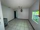 Dining room with tile floors and a chandelier ready to be renovated at 2402 E 148Th Ave, Lutz, FL 33549