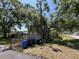 Eye-level view of the house, with foliage in the foreground at 2402 E 148Th Ave, Lutz, FL 33549