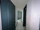Hallway with tile floors leading to other rooms needing to be renovated at 2402 E 148Th Ave, Lutz, FL 33549