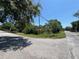 Intersection with street sign and some foliage obscuring the house at 2402 E 148Th Ave, Lutz, FL 33549