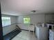 View of Laundry room with washer, dryer and window awaiting renovation at 2402 E 148Th Ave, Lutz, FL 33549