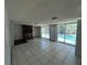 Large living room with fireplace and sliding glass doors leading to the pool area at 2402 E 148Th Ave, Lutz, FL 33549