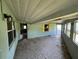 View of a screened-in porch with windows and door to outside at 2402 E 148Th Ave, Lutz, FL 33549