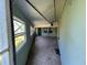 View of a screened-in porch with windows and door to outside at 2402 E 148Th Ave, Lutz, FL 33549