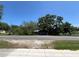 Street view of the property showing the metal carport and foliage at 2402 E 148Th Ave, Lutz, FL 33549