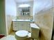 Bathroom featuring tile walls and floors, framed mirror, and a white vanity with drawers at 250 Rosery Nw Rd # 218, Largo, FL 33770