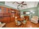 Elegant dining room with hardwood floors, a ceiling fan, and ample built-in storage at 250 Rosery Nw Rd # 218, Largo, FL 33770