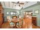 Open-concept dining area with hardwood floors, a ceiling fan, and an adjoining kitchen at 250 Rosery Nw Rd # 218, Largo, FL 33770