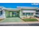 Charming single-story home with a covered parking area and a well-manicured front yard at 250 Rosery Nw Rd # 218, Largo, FL 33770