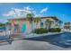 Community Recreation Center with a turquoise door, palm trees and fresh landscaping at 250 Rosery Nw Rd # 218, Largo, FL 33770