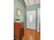 Cozy foyer with wood flooring, a decorative table, and a welcoming ambiance at 250 Rosery Nw Rd # 218, Largo, FL 33770