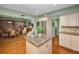 Bright kitchen with stainless steel appliances, tile backsplash, and wood flooring at 250 Rosery Nw Rd # 218, Largo, FL 33770