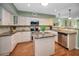 Bright kitchen with stainless steel appliances, tile backsplash, and a center island at 250 Rosery Nw Rd # 218, Largo, FL 33770