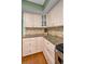 Kitchen featuring granite countertops, cream colored cabinets, and wood flooring at 250 Rosery Nw Rd # 218, Largo, FL 33770