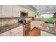 Kitchen featuring stainless steel oven and microwave, with granite countertops at 250 Rosery Nw Rd # 218, Largo, FL 33770