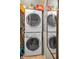 Practical laundry area with stacked washer and dryer, plus extra storage at 250 Rosery Nw Rd # 218, Largo, FL 33770