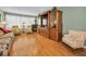 Open-concept living room featuring hardwood floors, TV, and a cozy fireplace at 250 Rosery Nw Rd # 218, Largo, FL 33770