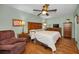 Comfortable bedroom with hardwood floors and a large bed at 250 Rosery Nw Rd # 218, Largo, FL 33770