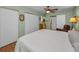 Bright bedroom featuring hardwood floors, white closets, and an ensuite at 250 Rosery Nw Rd # 218, Largo, FL 33770