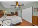 Bedroom featuring hardwood floors, a ceiling fan and lots of storage at 250 Rosery Nw Rd # 218, Largo, FL 33770