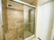A glass shower with a built-in bench is tiled with a tiled floor at 250 Rosery Nw Rd # 218, Largo, FL 33770