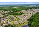 A stunning aerial view showcasing a neighborhood filled with serene ponds and lush green landscaping at 31108 Whitlock Dr, Wesley Chapel, FL 33543