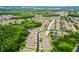 Wide aerial shot of the neighborhood with trees and a pond at 31108 Whitlock Dr, Wesley Chapel, FL 33543