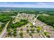 Expansive aerial view showcasing the community, complete with serene ponds and verdant woods at 31108 Whitlock Dr, Wesley Chapel, FL 33543