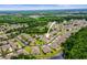 Stunning aerial perspective of the community, featuring picturesque ponds and lush forest backdrop at 31108 Whitlock Dr, Wesley Chapel, FL 33543