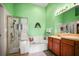 Bathroom with dual sinks, walk-in shower, and soaking tub at 31108 Whitlock Dr, Wesley Chapel, FL 33543