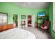 Green bedroom with tiled floor. Includes en-suite bathroom at 31108 Whitlock Dr, Wesley Chapel, FL 33543
