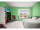 Bright bedroom featuring a large window with a cushioned seating area and a television at 31108 Whitlock Dr, Wesley Chapel, FL 33543