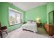 Green bedroom with tiled floors, large window, and cozy seat at 31108 Whitlock Dr, Wesley Chapel, FL 33543