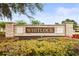 Elegant stone community sign for Whitlock, set amongst landscaped foliage at 31108 Whitlock Dr, Wesley Chapel, FL 33543