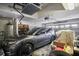 Organized garage with ample space for parking and storage solutions; includes water heater and shelving at 31108 Whitlock Dr, Wesley Chapel, FL 33543